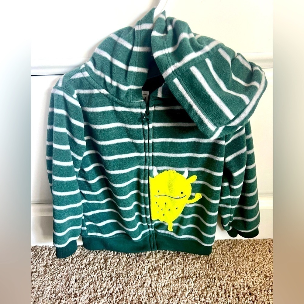 Carters fleece zip up. Green with with stripes and small light green monster.